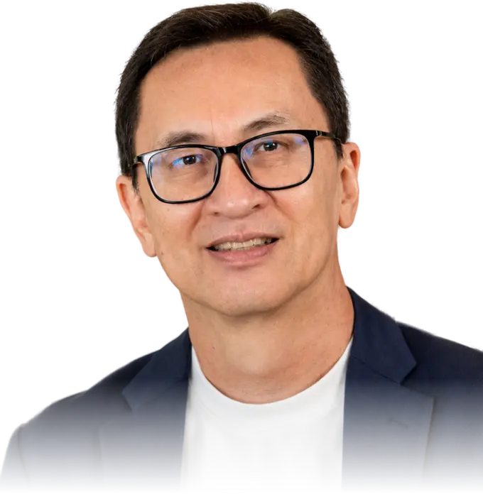 Timothy Hor, smiling, in a navy jacket and white t-shirt